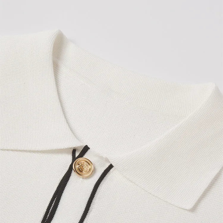 White short-sleeve women's V-neck cardigan with dark contrasting lapels laid flat.