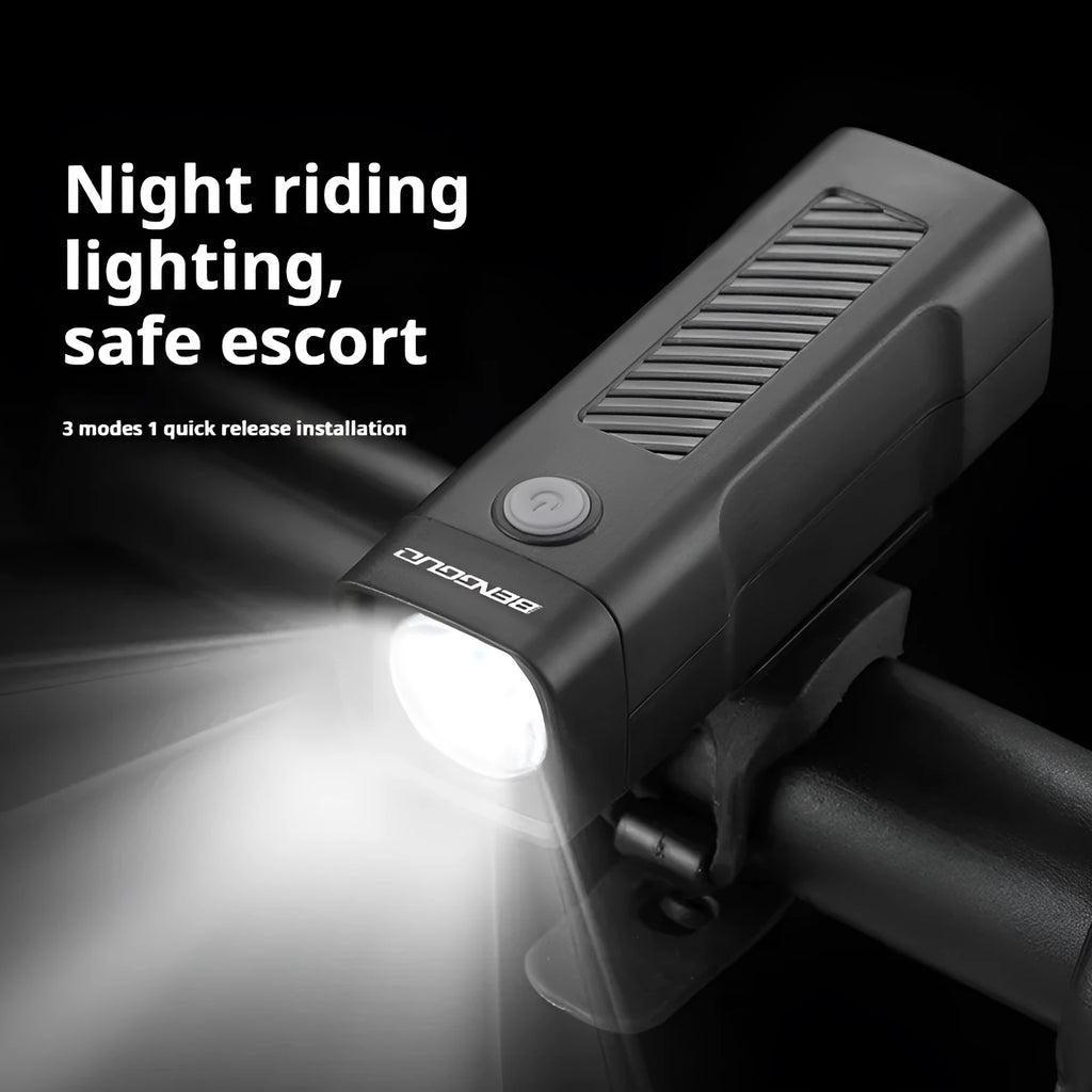 Black bicycle headlight with quick release strap bracket mounted on handlebars