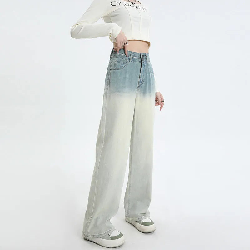 Gradient blue straight-leg denim trousers for women on a hanger, showing the wide-leg cut and colour fade.