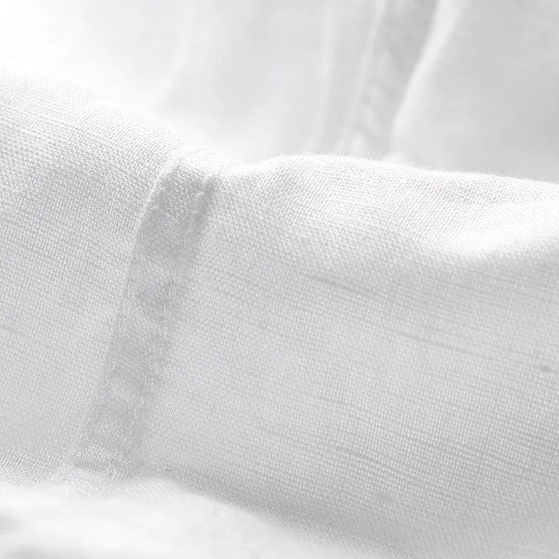 Men's light blue linen short sleeve shirt with a square collar on a hanger.