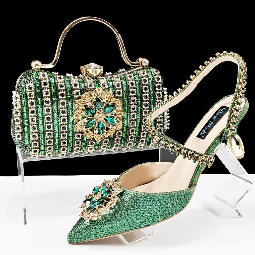 Women's black high-heel ankle strap sandal with rhinestone flower buckle and matching hard clutch bag.