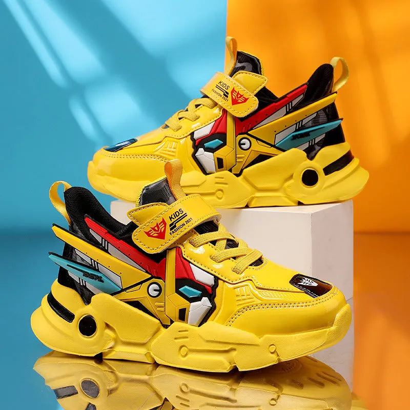 Boy's yellow artificial leather running shoes with Velcro strap and cartoon pattern, shown on a rubber sole.