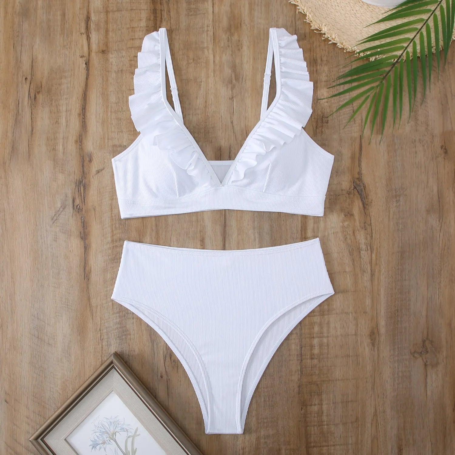 Women's black and white striped bikini with split chest design on a mannequin.