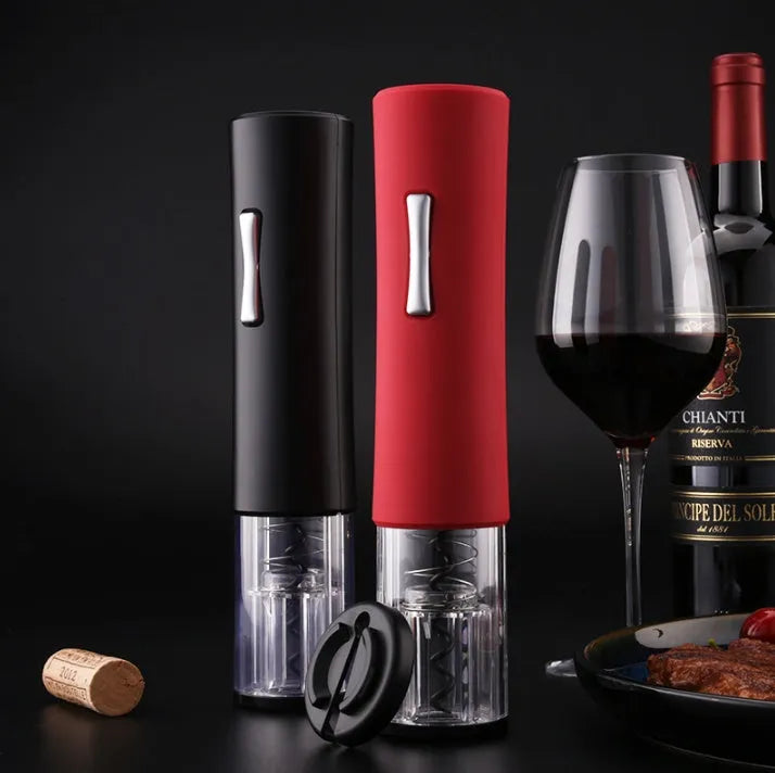 Automatic electric wine opener with black ABS shell and foil cutter set on a table alongside a wine bottle