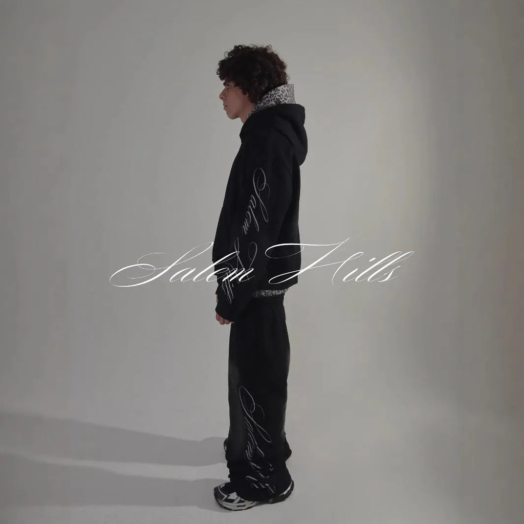 Men's grey punk print pullover hoodie and matching trousers laid flat.