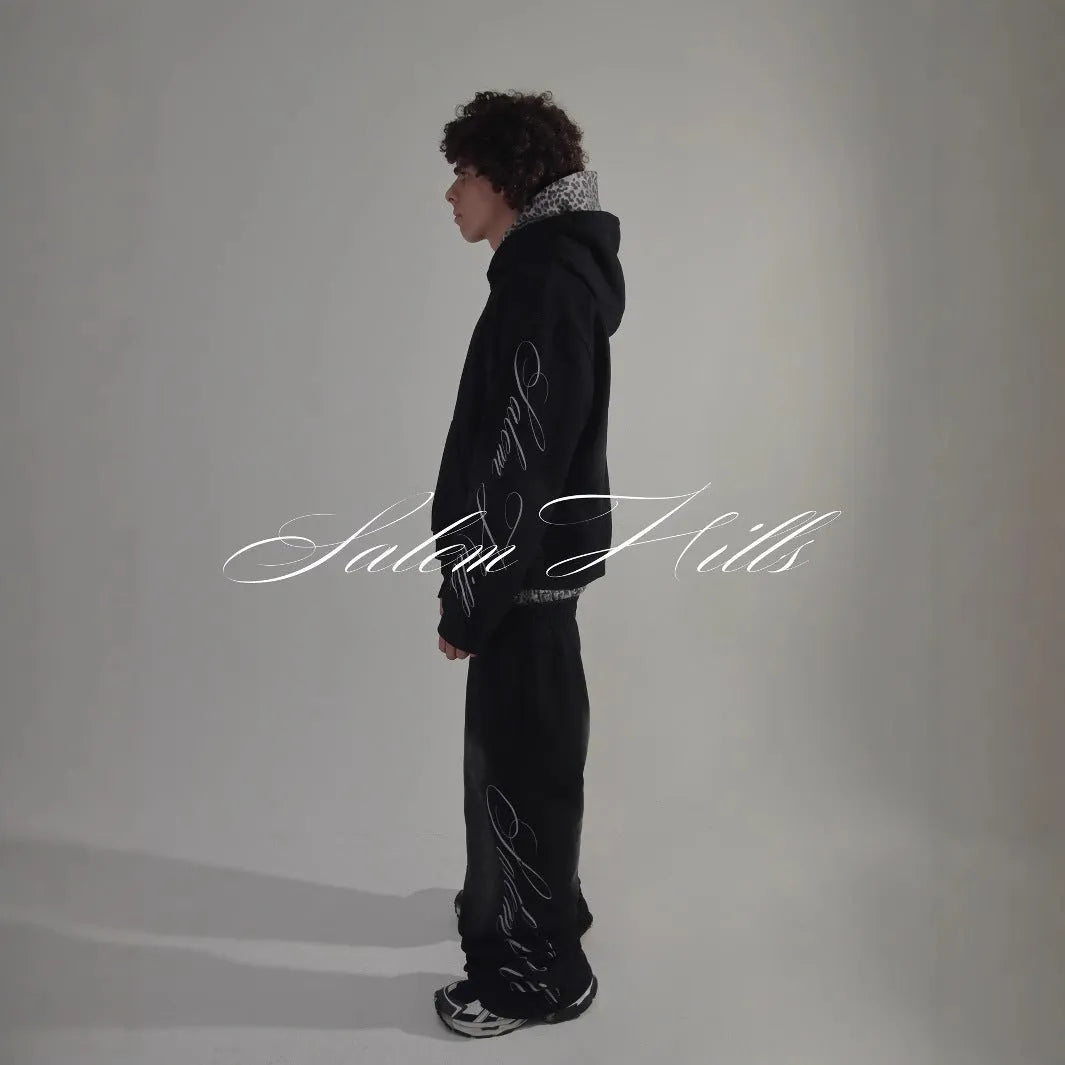 Men's grey punk print pullover hoodie and matching trousers laid flat.