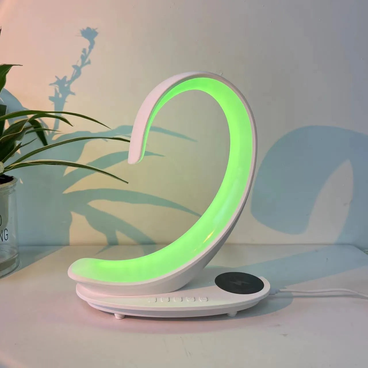 White swan decorative desk lamp with colourful RGB lighting, Bluetooth speaker, and wireless charging pad