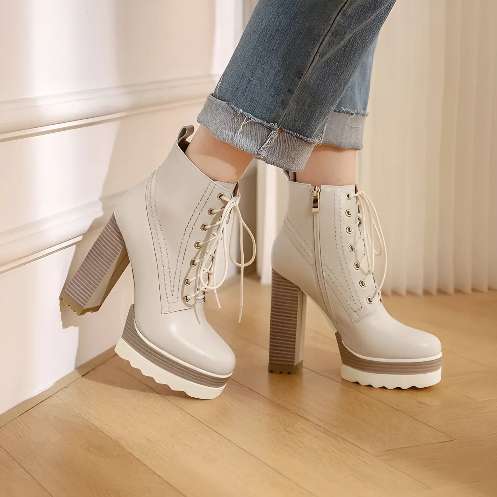 Women's black waterproof platform boots with a chunky heel and side zip fastening on a white background.