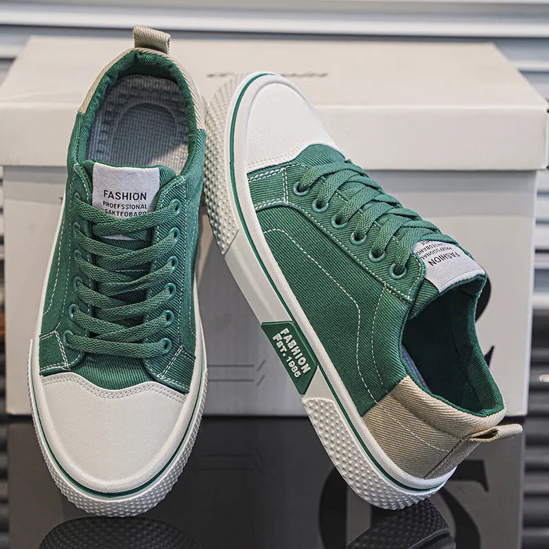 Men's low top casual canvas shoes in blue with round toe and front lace-up, on a plain background.