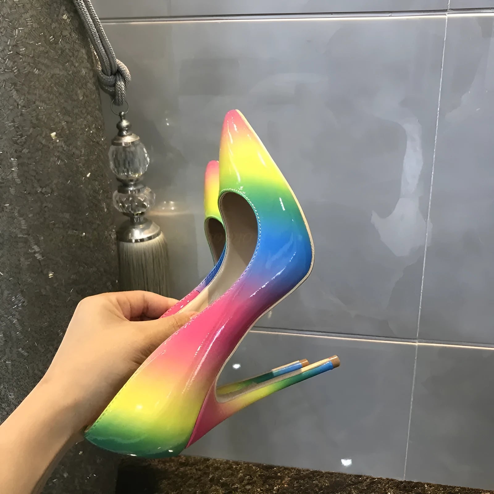 Rainbow glossy patent leather women's ultra-high heel shoes with a pointed toe and thin stiletto.