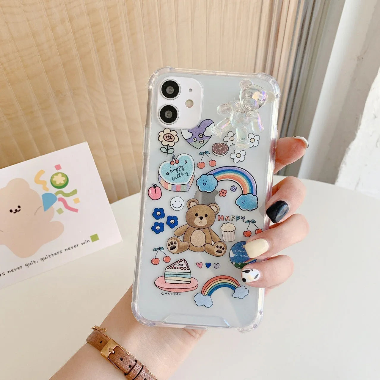 Clear TPU iPhone case with an attached bear chain and cartoon pendant charm