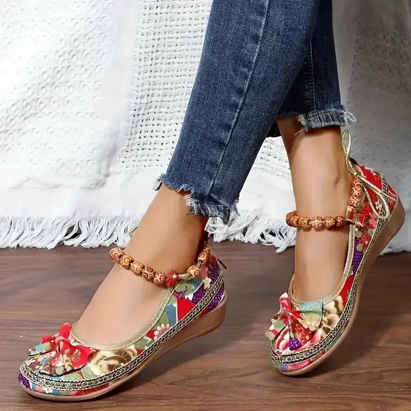 Women's plus size black ethnic platform sandals with cloth upper and elastic band, shown from the side.