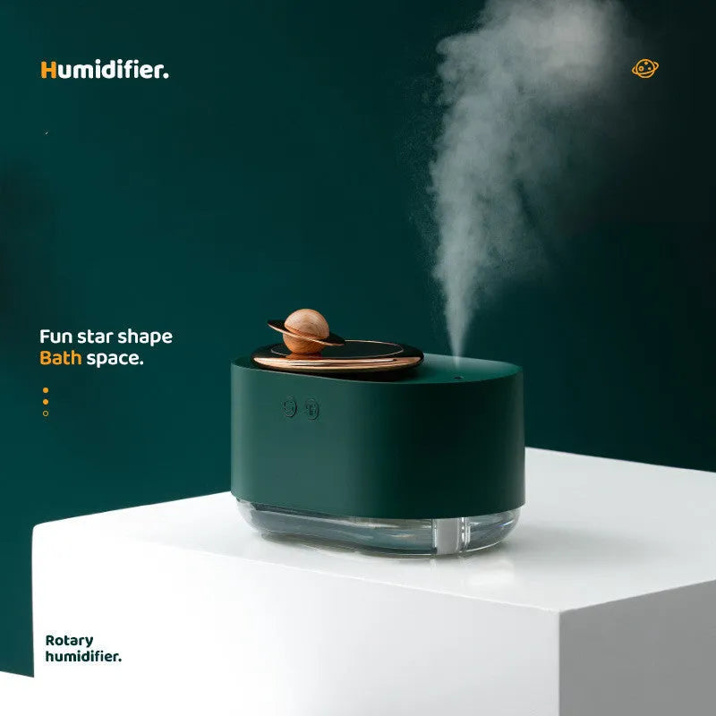 Green rotating planet humidifier with USB cable on desk showing night light illumination