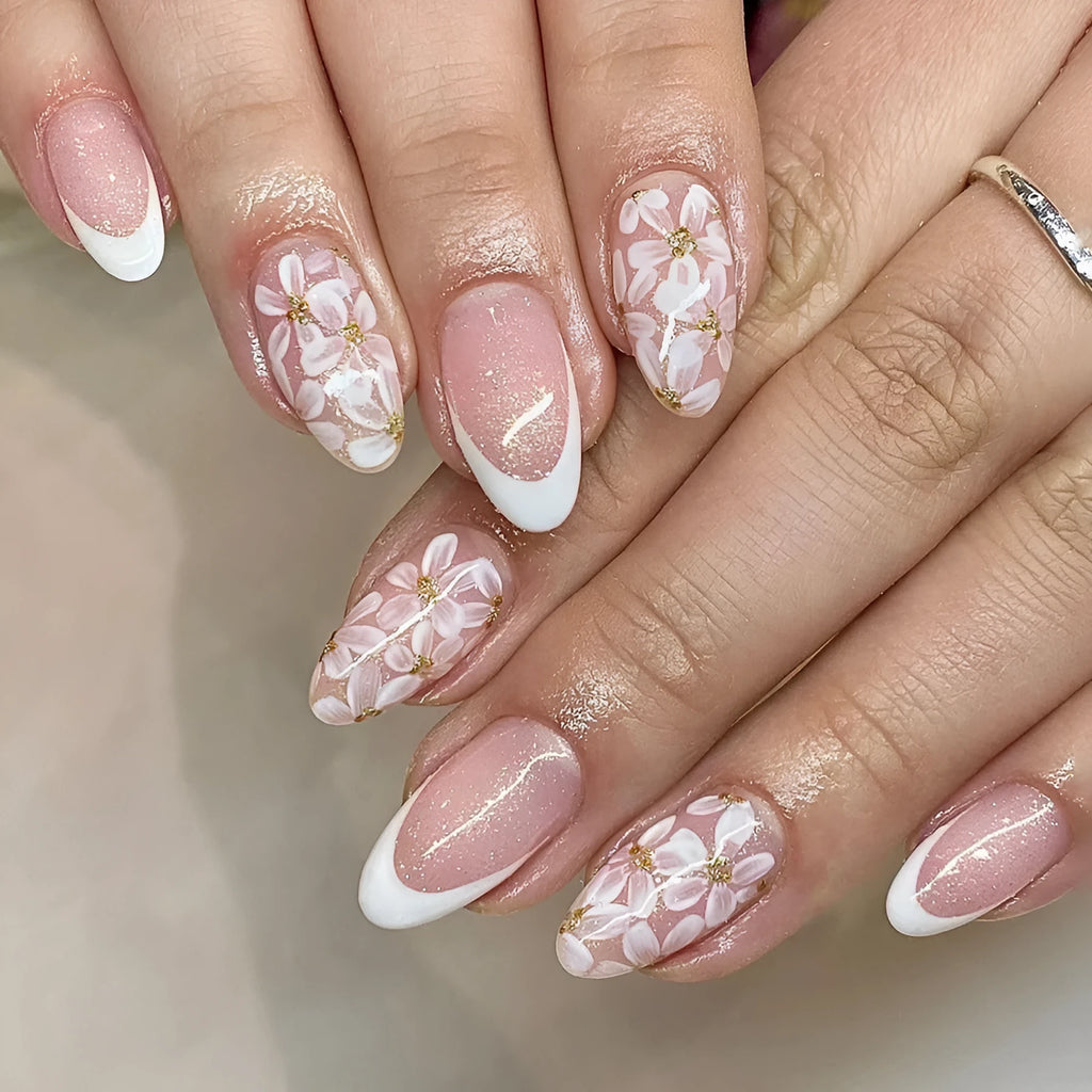 Short almond-shaped false nails with French style glitter and flower designs in colour C625