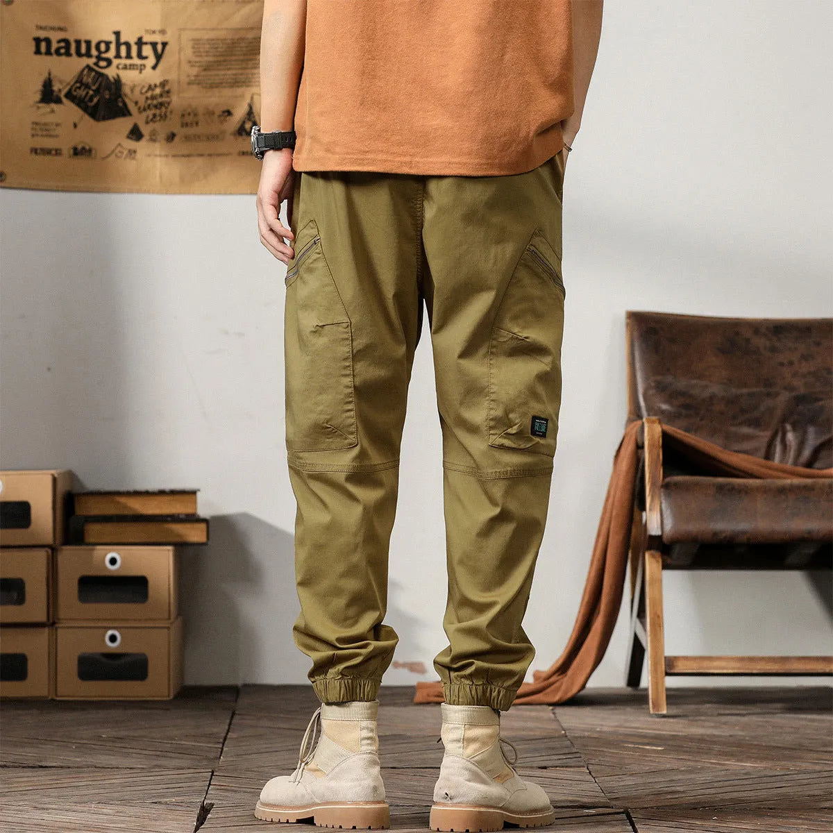Men's khaki cotton harem pants with tapered leg and ankle band on a mannequin.