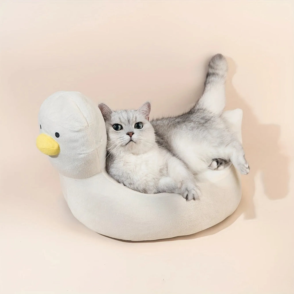 Blue duck-shaped fluffy pet bed for small dogs and cats on a wooden floor.