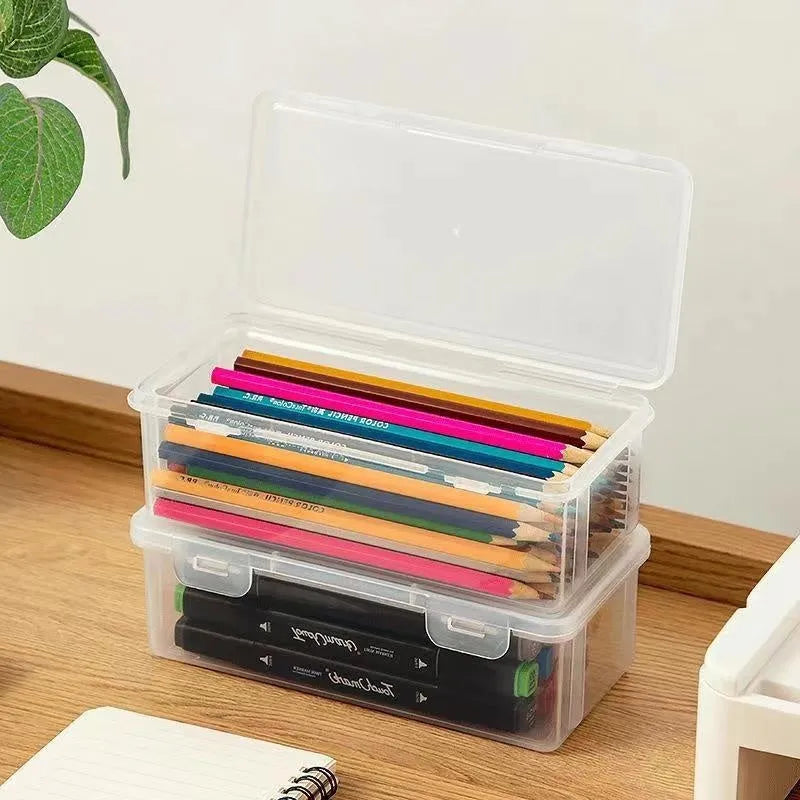 Large transparent plastic stationery storage box holding coloured pencils and crayons.