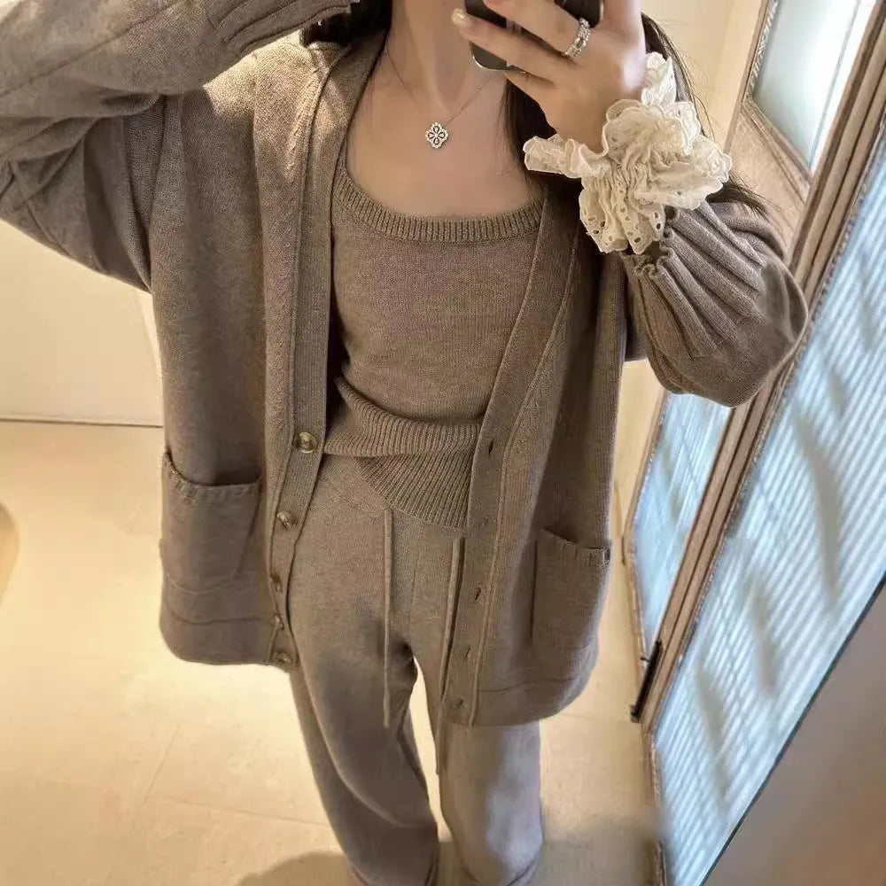 Women's light brown knit cardigan, vest, and casual pants three-piece set laid flat.