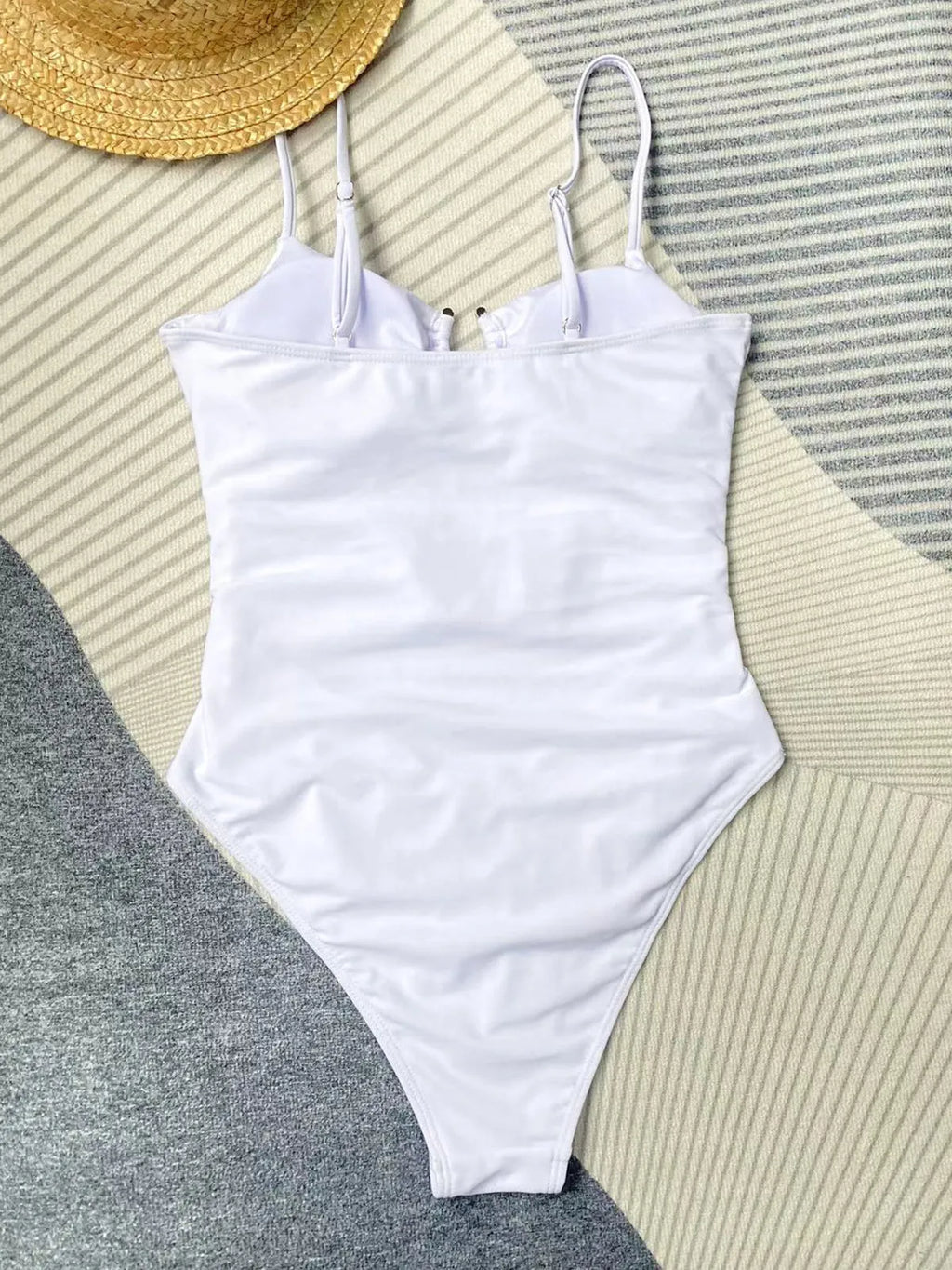 Women's black solid colour one-piece swimsuit with figure-hugging design on mannequin