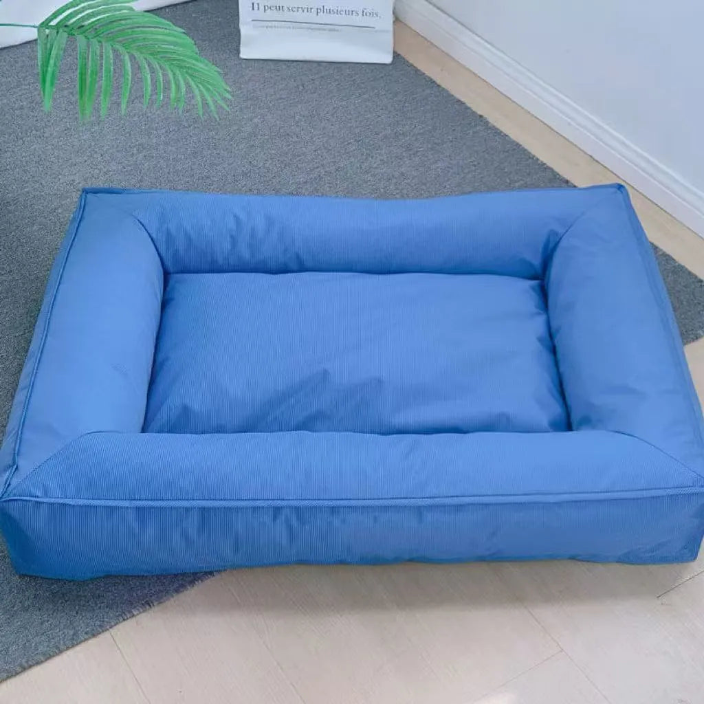 Orthopedic dog bed in waterproof Oxford cloth with full surround support, shown in blue, dark green, and grey