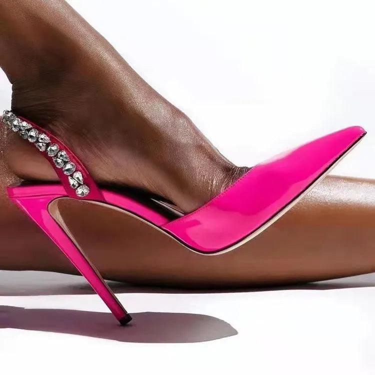 Women's black patent leather rhinestone pointed toe high heel sandals on a white background.