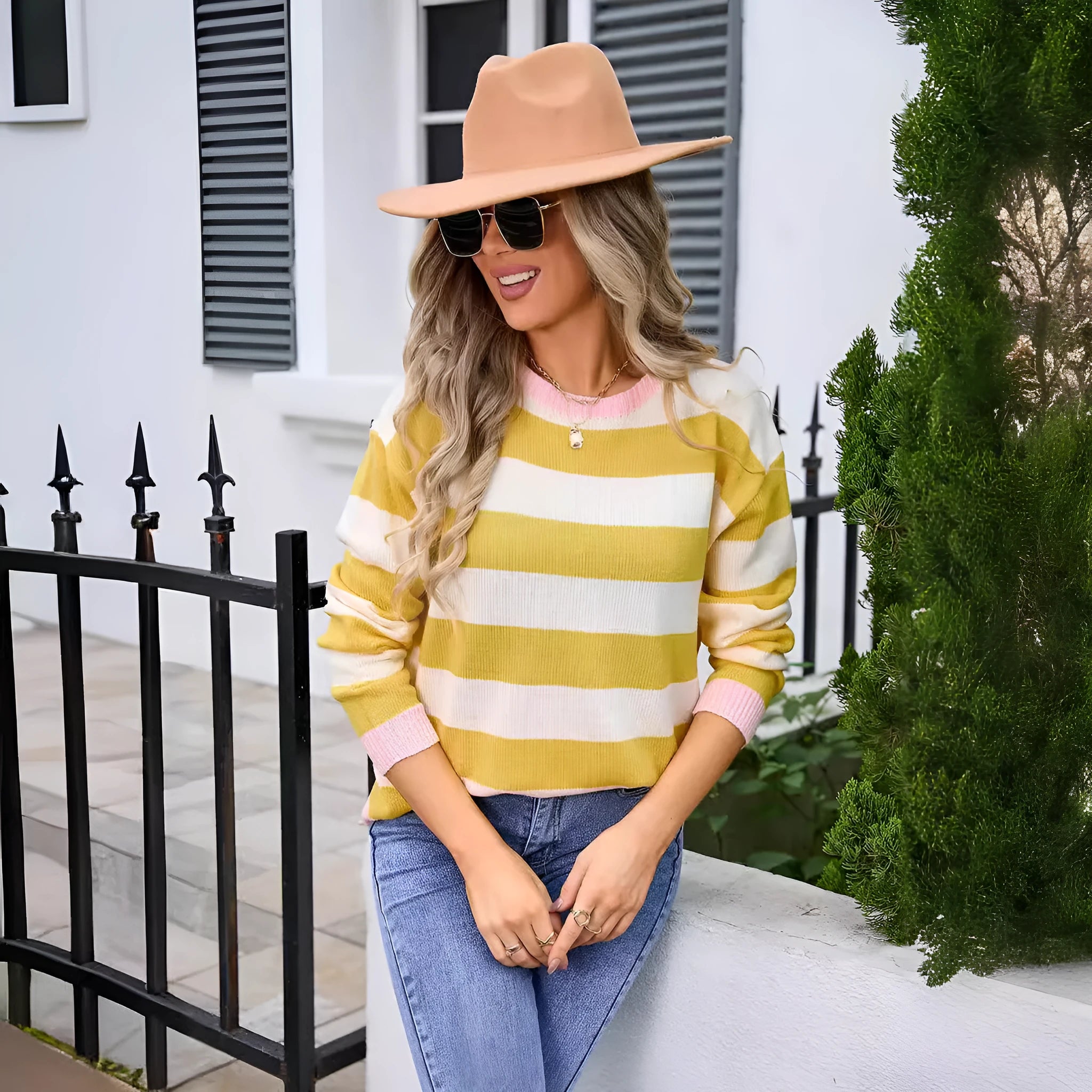 Women's loose blue striped acrylic knit sweater with long sleeves on a hanger.