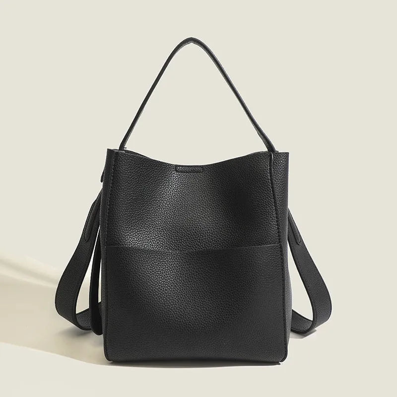 Soft PU bucket messenger bag in elephant gray with visible sewing line detailing, outer sandwich pocket, and single shoulder strap.