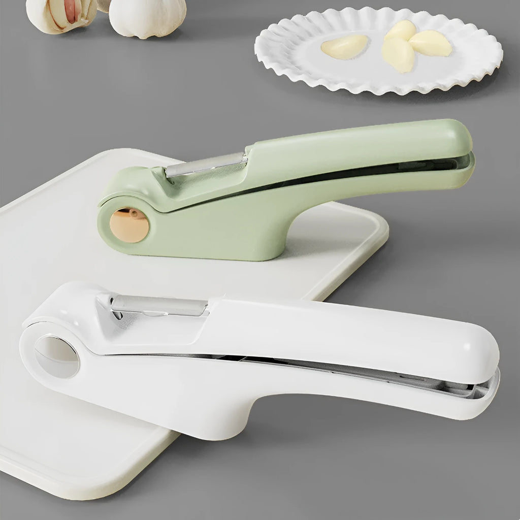 White manual garlic press with stainless steel crusher on a kitchen worktop.