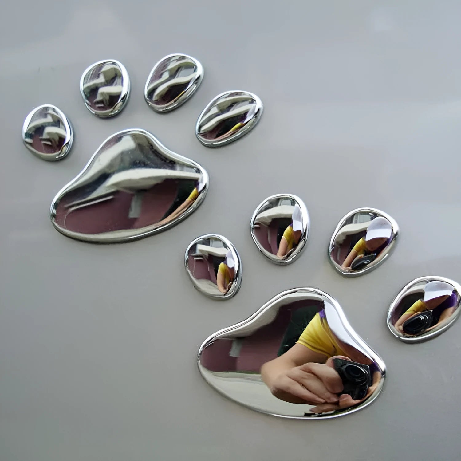 PVC dog footprint car sticker showing hand-shaped brush design on vehicle bumper