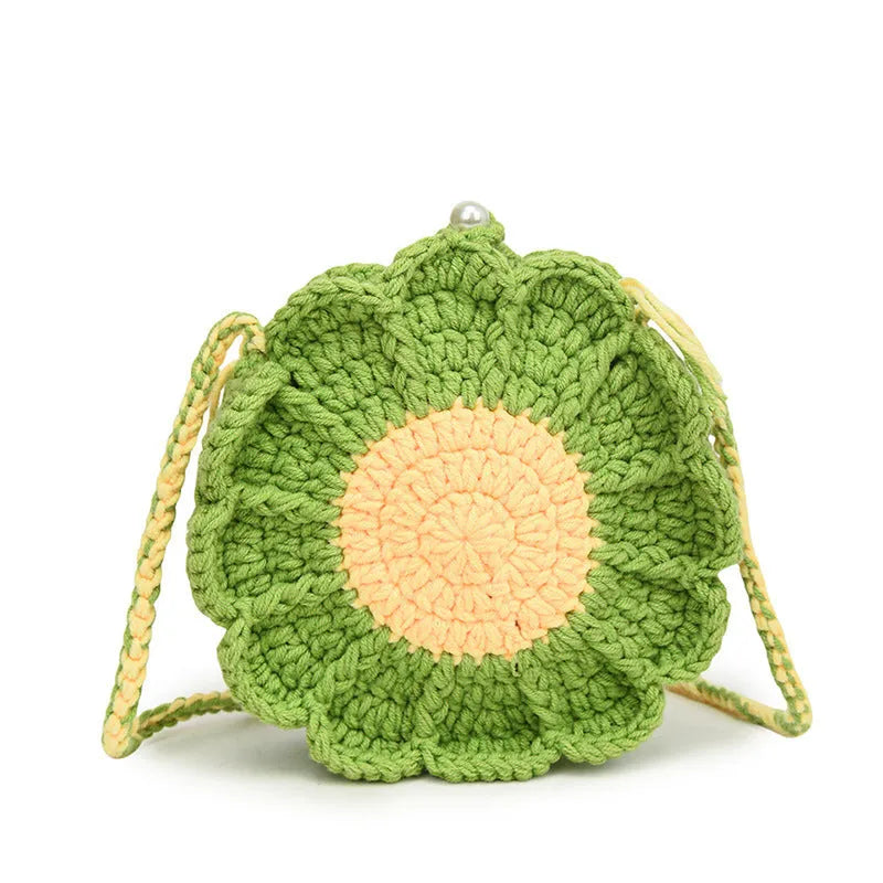 Hand-woven round bag with crocheted flowers showing cotton lining and mobile phone pouch