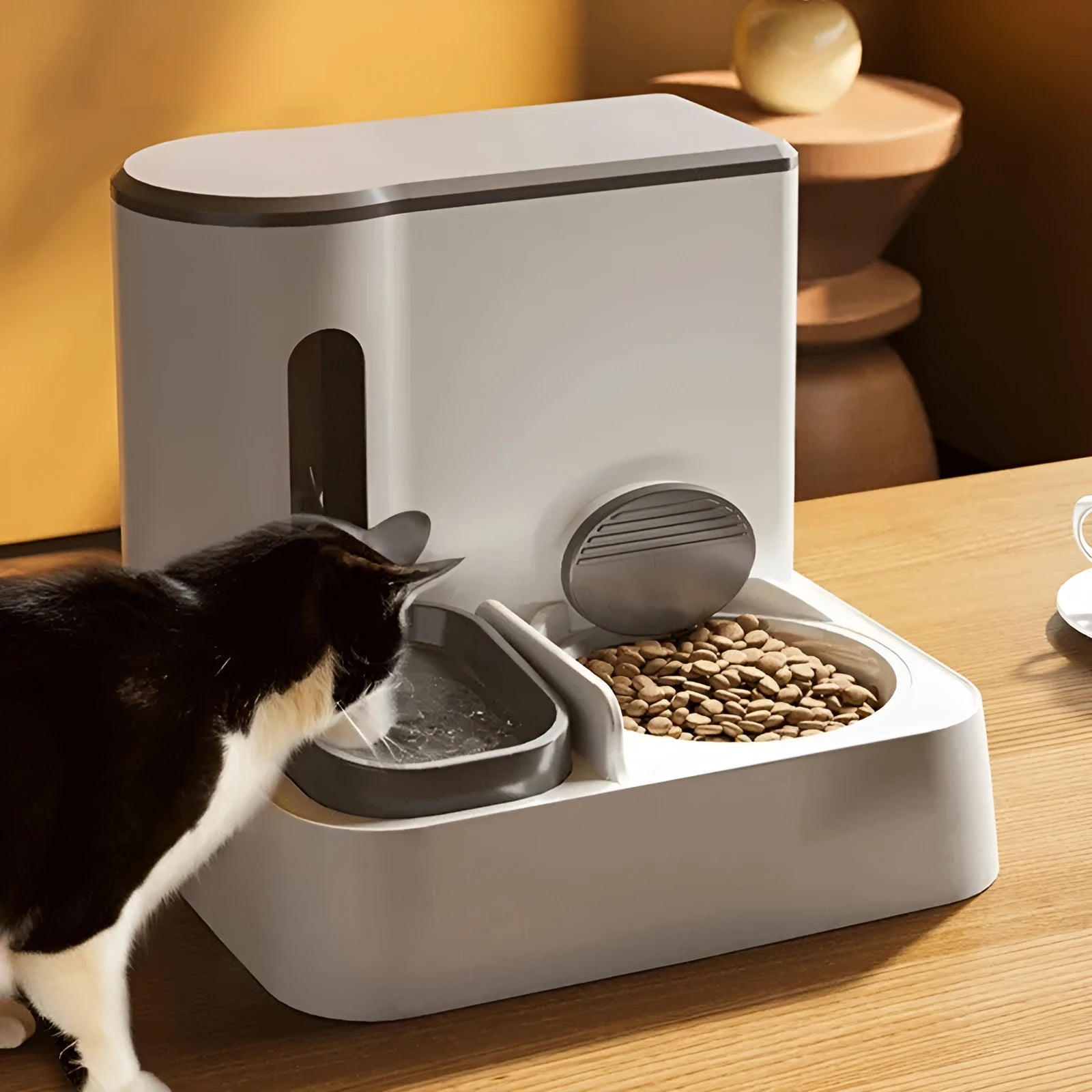 Grey automatic cat feeder with integrated water dispenser and stainless steel bowl