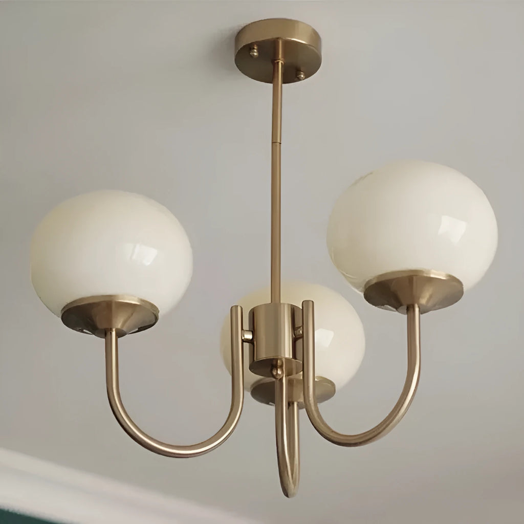 Three-head creative LED chandelier with glass lampshades and iron frame in copper pink finish for living room