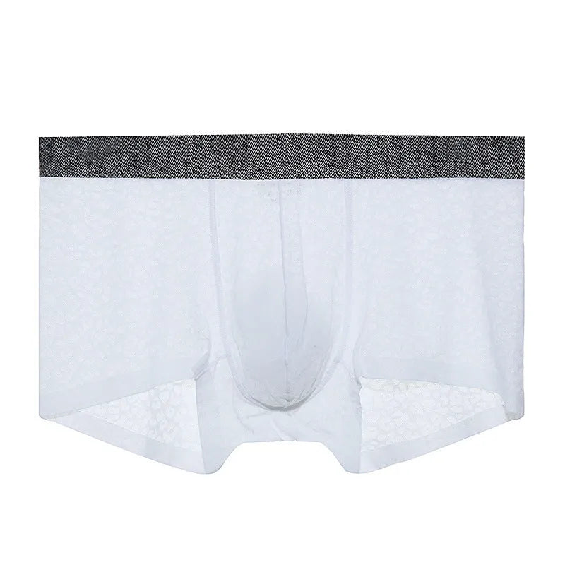 Man wearing seamless lace boxer briefs in a solid colour with low-waist design.