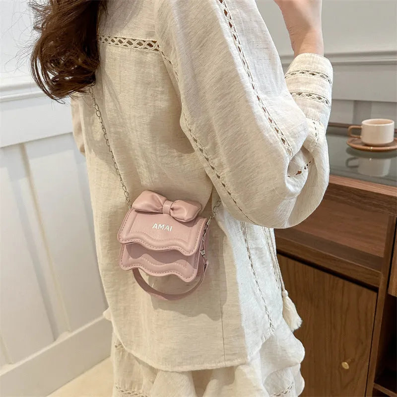 Mini crossbody bag in PU leather with adjustable strap shown in seven colour options