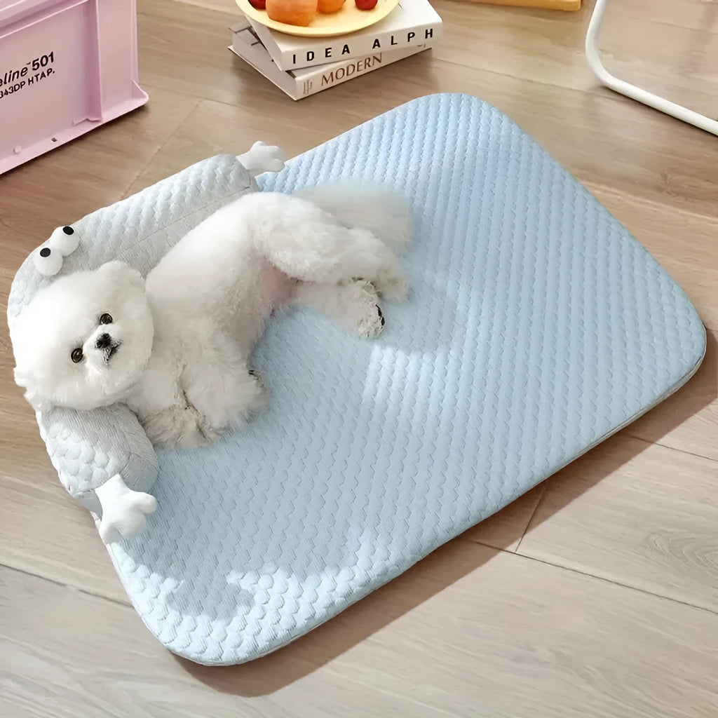 Blue pet bed cushion with big-eyed monster design for dogs and cats on a wooden floor