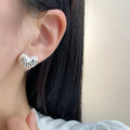 Heart-shaped copper earrings with electroplating, shown as gold or silver ear clips or studs, one pair.