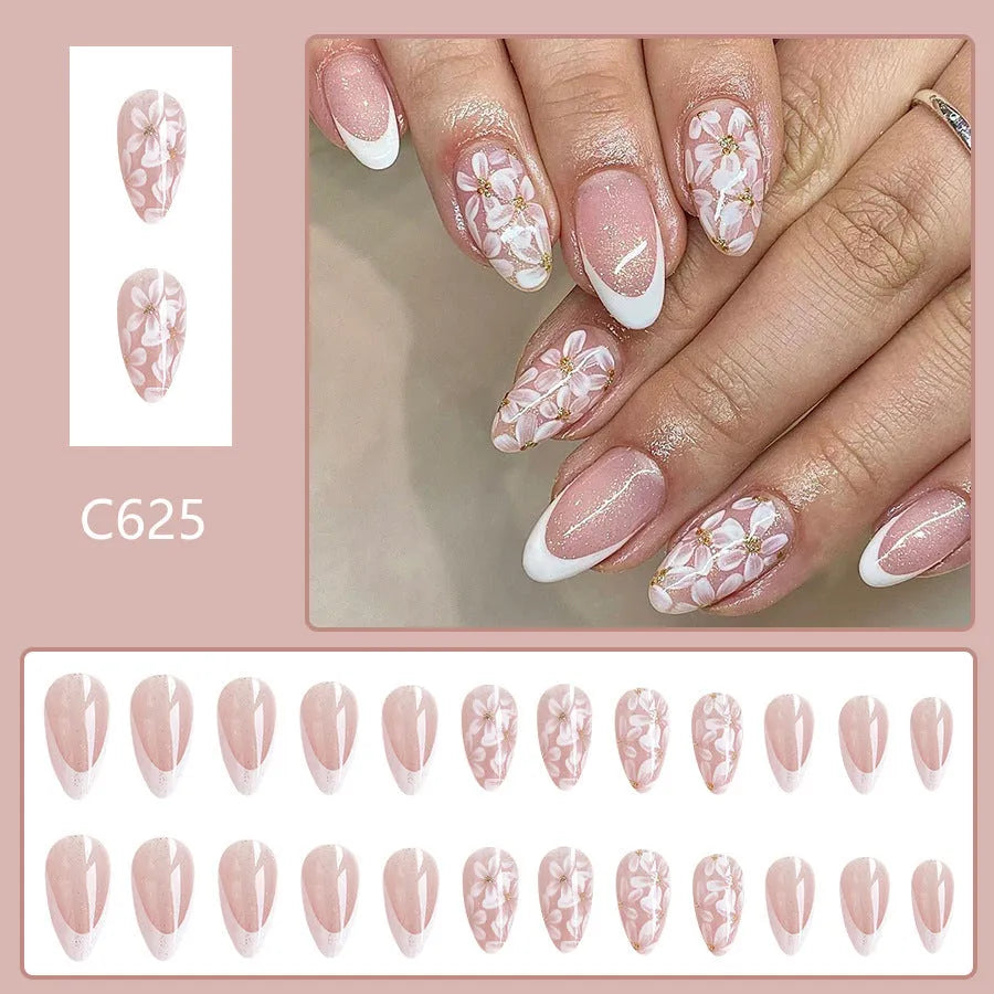 Short almond-shaped false nails with French style glitter and flower designs in colour C625