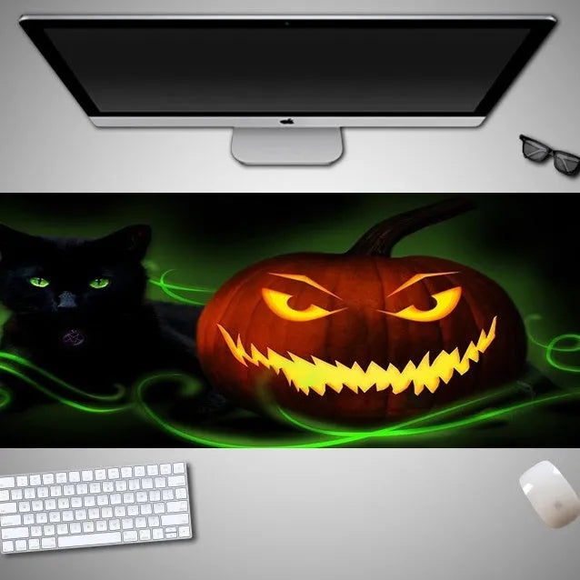 Oversized Halloween-themed gaming mouse pad with non-slip rubber base on a desktop