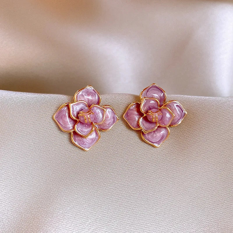 Gold plated purple oil-spot glaze flower stud earrings on a copper base.