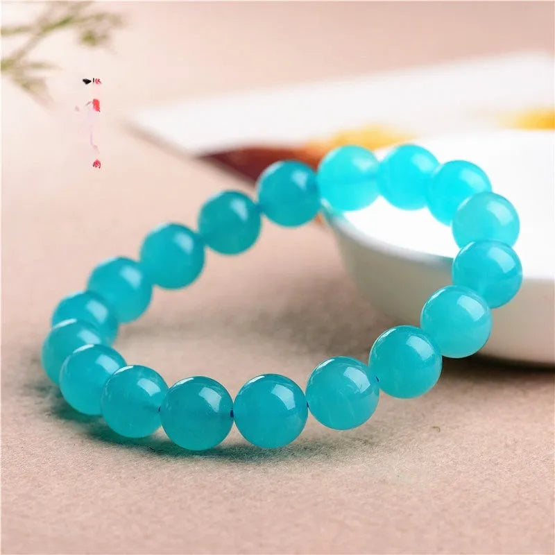 Loose polished Grade 7A Amazonite beads in various sizes on a white background.