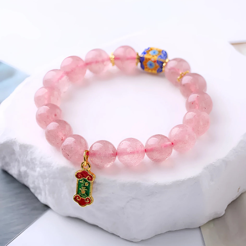 Pink strawberry quartz crystal bracelet with Ruyi charm and hand-woven design for women.