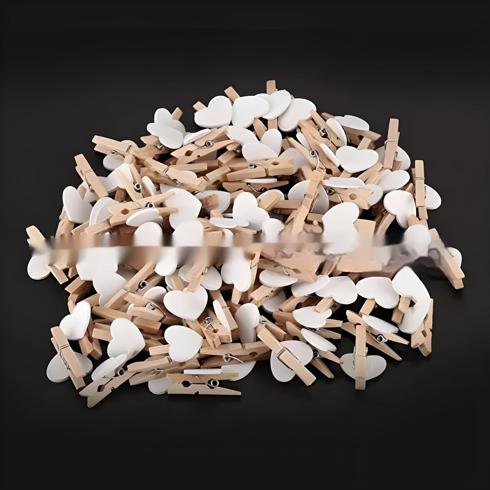 Five small wooden heart-shaped clips in red, pink, yellow, white, and rose red colours on a neutral background.