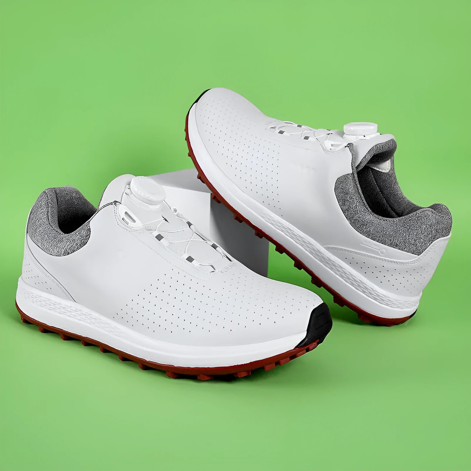 Men's white and black casual low-top golf shoes with breathable hollow-out design and non-slip sole.