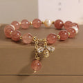 Women's bracelet with strawberry quartz beads, freshwater pearls, and zircon crystals on gold-tone clasp