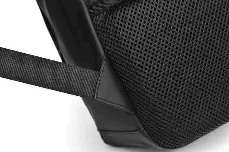 Men's large waterproof black PU leather backpack with laptop compartment on a grey background.