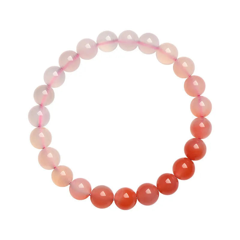 Natural gradient Yanyuan agate bracelet with geometric beads on a wrist, showing salt source colour variation.