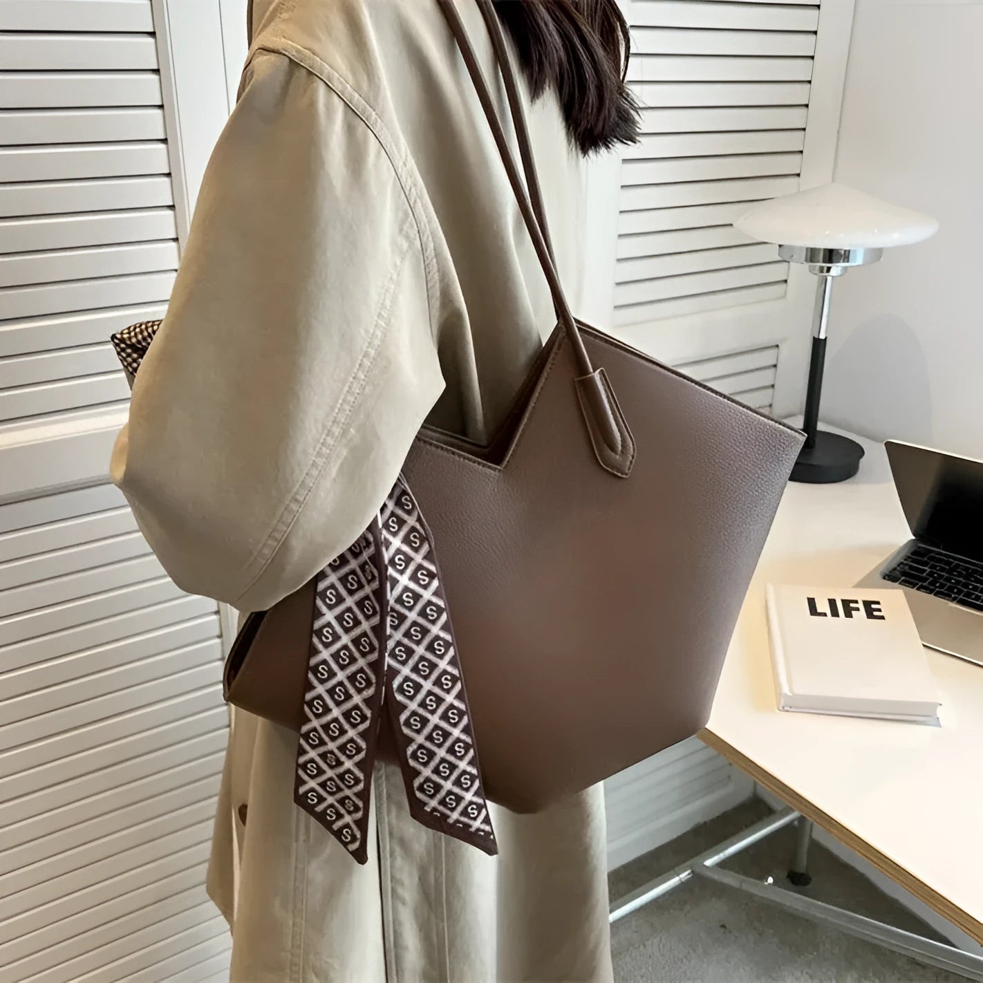 Women's large beige PU leather shoulder bag with a square shape and single handle on a neutral background.