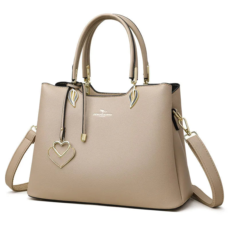 Women's black PU leather messenger bag with shoulder strap and sewing thread detail.