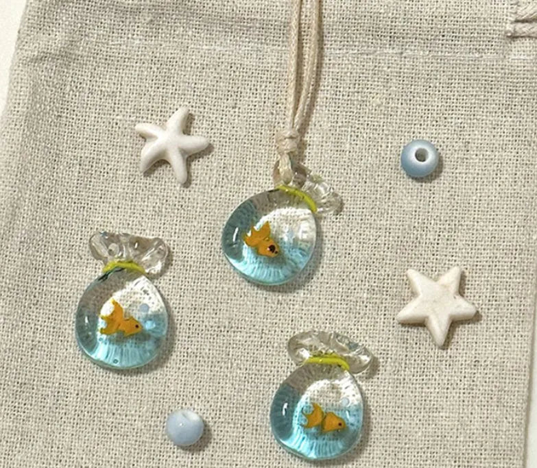 Women's joker pendant necklace with coloured glaze charm on a cotton and linen clavicle chain.