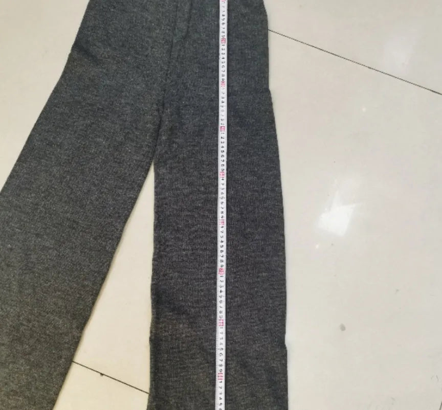 Women's dark grey casual suit with side-slit sweater top and matching trousers.